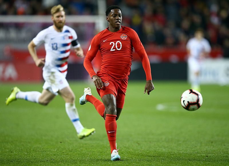 Jonathan David of Canada dribbles the ball